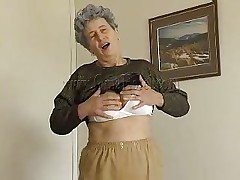 Hawt granny Rosa takes her clothes off and reveals that saggy tits of hers. She squeezes them for greater amount pleasure and lays down on the bed. The horny old lady spreads her legs and fingers her cunt a little. She has a dildo and is ready to play with it. Wanna watch her sucking and sticking it in her pussy?