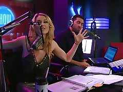 Playboy Radio's Morning Show has some of the hottest women you've ever seen! They're talking about Halloween costumes, and their guest has a cop outfit on that looks sexy as hell. It receives even sexier when her top comes off, baring her tits. The female host comes over and helps shorten the skirt.