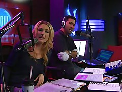 The hosts of Playboy Radio's Morning Show are looking at their guest model who is wearing the costume she'll be wearing to the Playboy Mansion for Halloween. Her head and tits are covered in fake fruit like oranges, limes, lemons, and more. She flashes her breasts for the hosts and viewers.